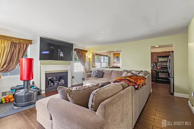 a living room with furniture a fireplace and a flat screen tv