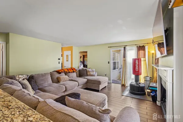 a living room with furniture a fireplace and a flat screen tv