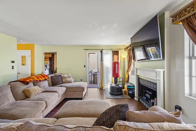 a living room with furniture fireplace and a window