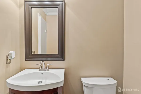 a bathroom with a toilet a sink and mirror
