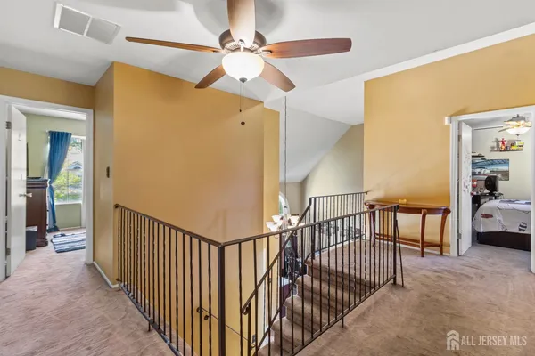 a view of a hallway with bedroom and a balcony