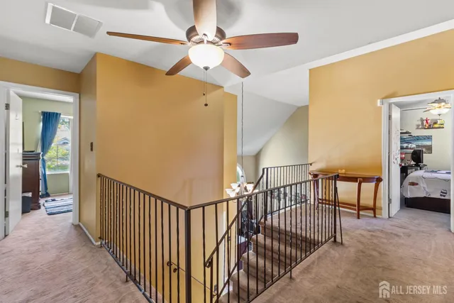 a view of a hallway with bedroom and a balcony