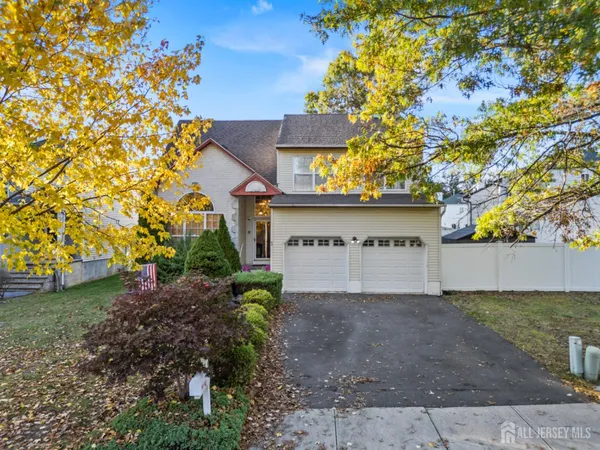 a view of a house with a tree and a yard