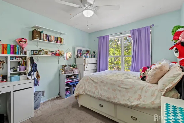 a bedroom that has a bed and a bookshelf