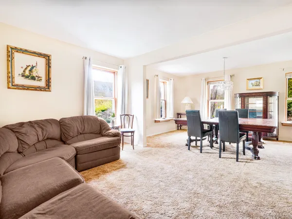 a living room with furniture dining area and a window