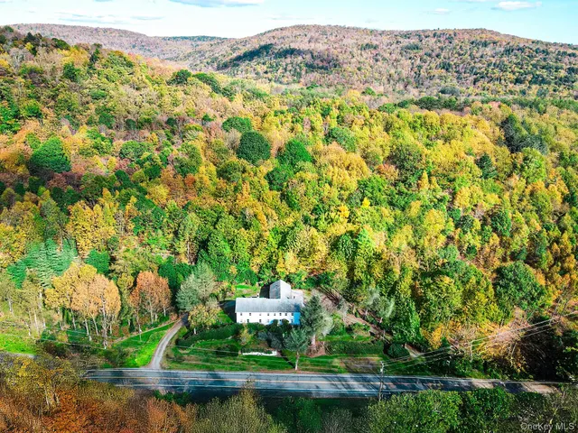 a living room with furniture dining area and a window