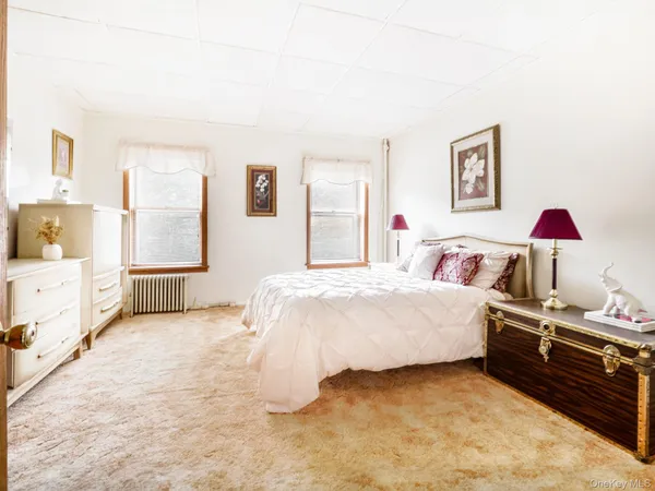 a bed room with a bed and a television