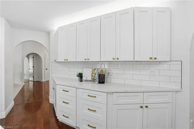 a kitchen with stainless steel appliances white cabinets and a sink