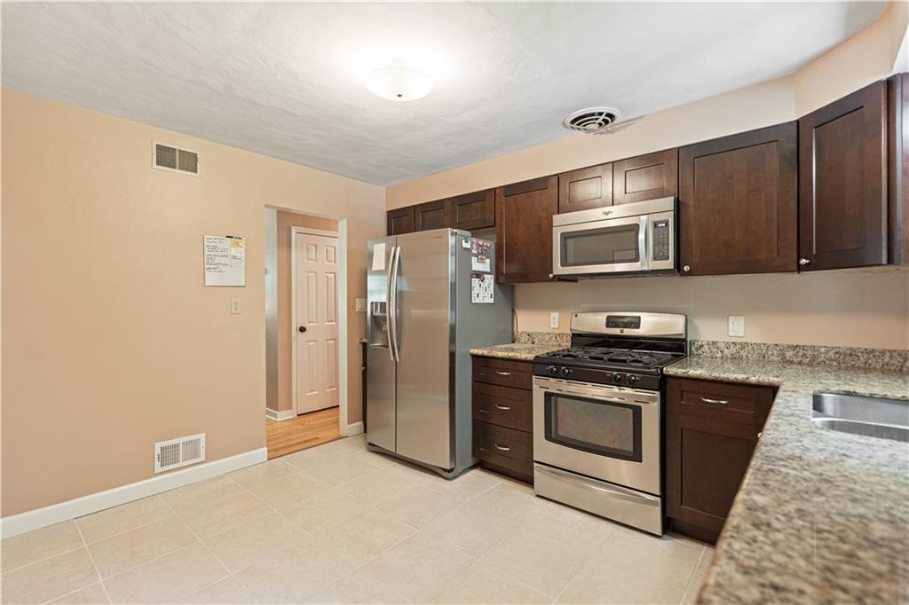 115 Maruth Drive Pittsburgh, PA 15237 - Photo 9 of 30 a kitchen with stainless steel appliances granite countertop a stove a refrigerator and a microwave