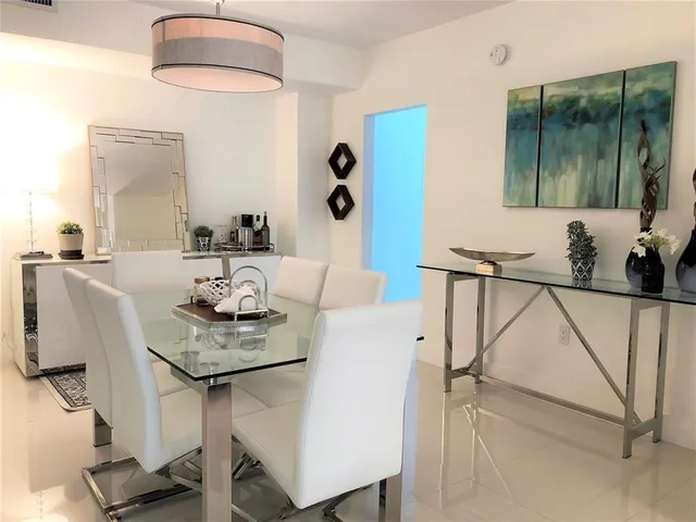 a dining room with furniture and a mirror