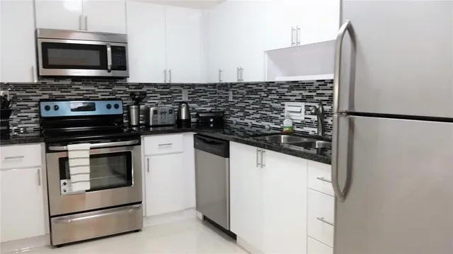 a kitchen with a stove and a microwave