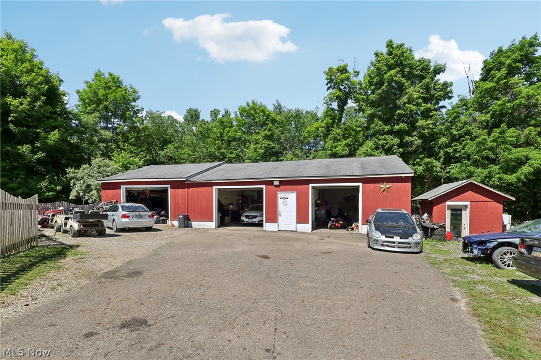 16146 Ravenna Road Burton, OH 44021 - Photo 25 of 27 View of front facade featuring a garage and an outdoor structure