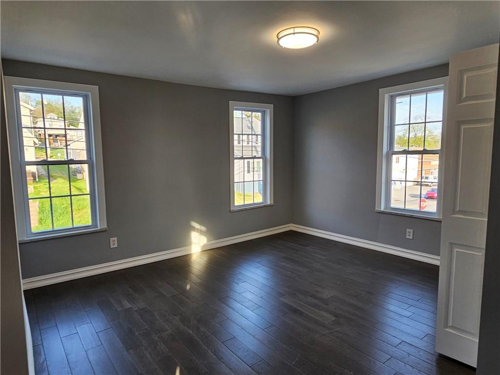 536 Virginia Avenue Rochester, PA 15074 - Photo 16 of 24 a view of an empty room with wooden floor and a window