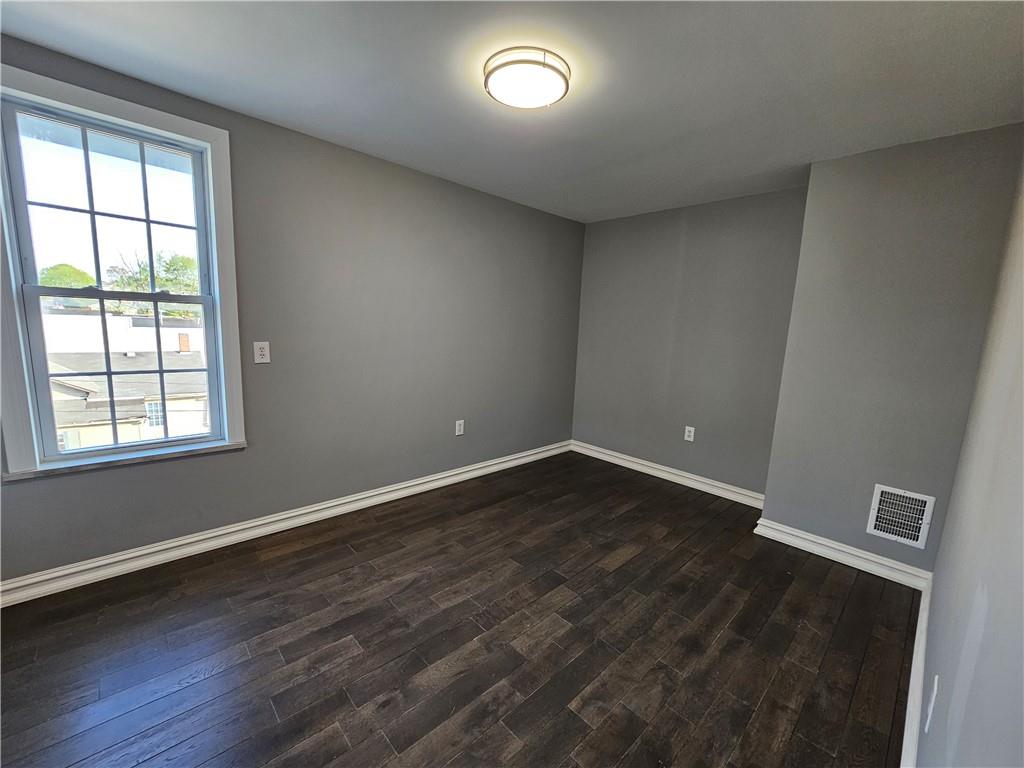 536 Virginia Avenue Rochester, PA 15074 - Photo 18 of 24 an empty room with wooden floor and windows