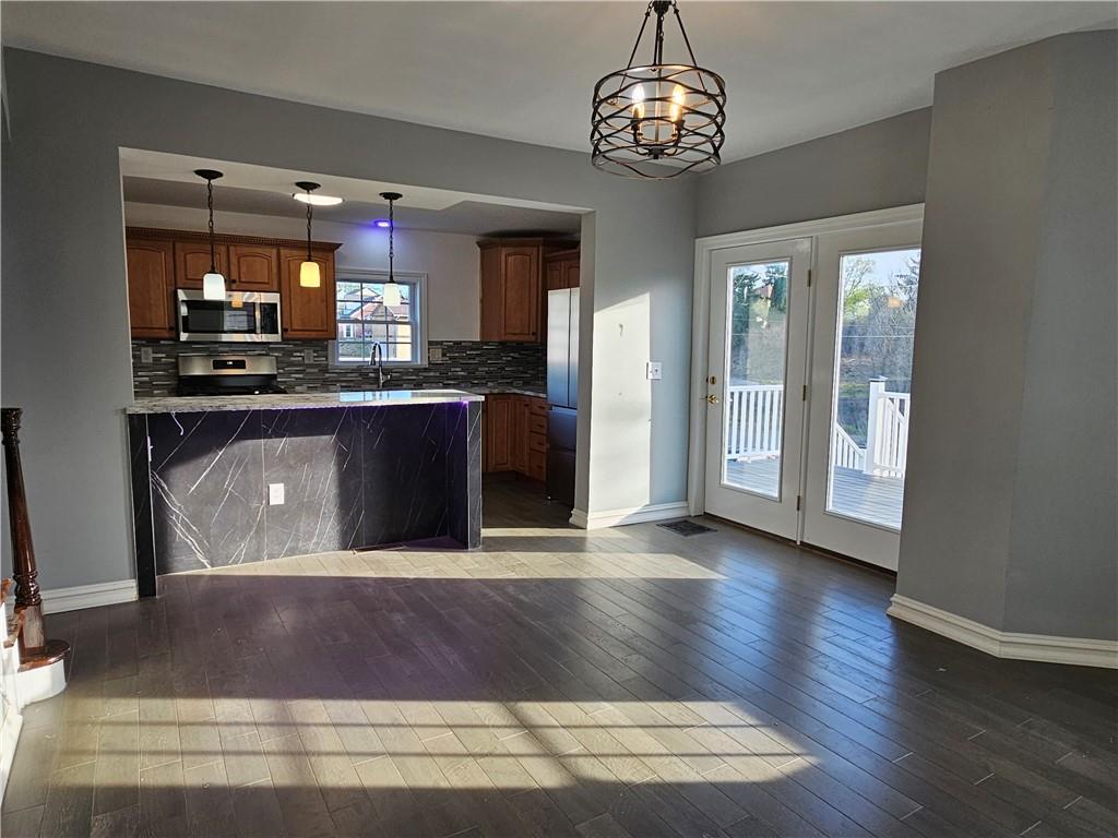 536 Virginia Avenue Rochester, PA 15074 - Photo 23 of 24 a kitchen with stainless steel appliances granite countertop a stove and a refrigerator