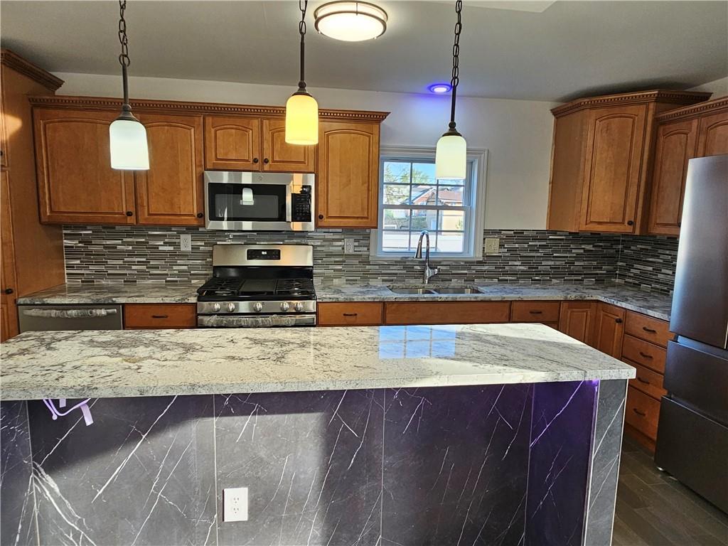 536 Virginia Avenue Rochester, PA 15074 - Photo 7 of 24 a kitchen with stainless steel appliances granite countertop a sink a microwave counter space and wooden floor