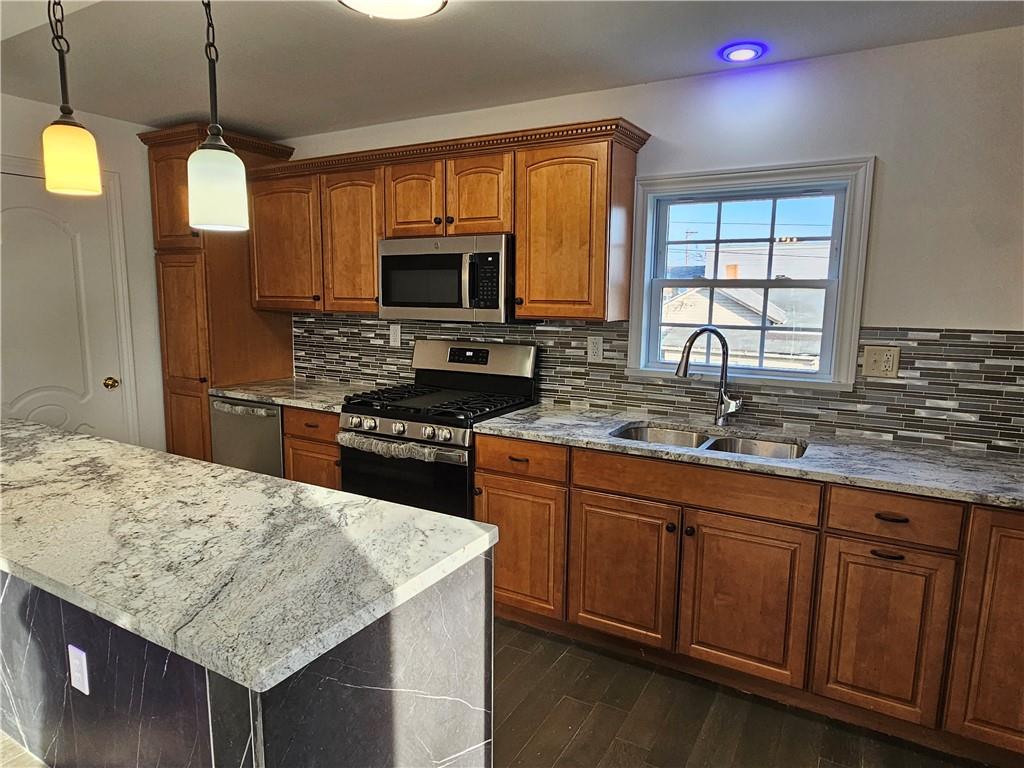 536 Virginia Avenue Rochester, PA 15074 - Photo 8 of 24 a kitchen with stainless steel appliances granite countertop a sink stove and refrigerator