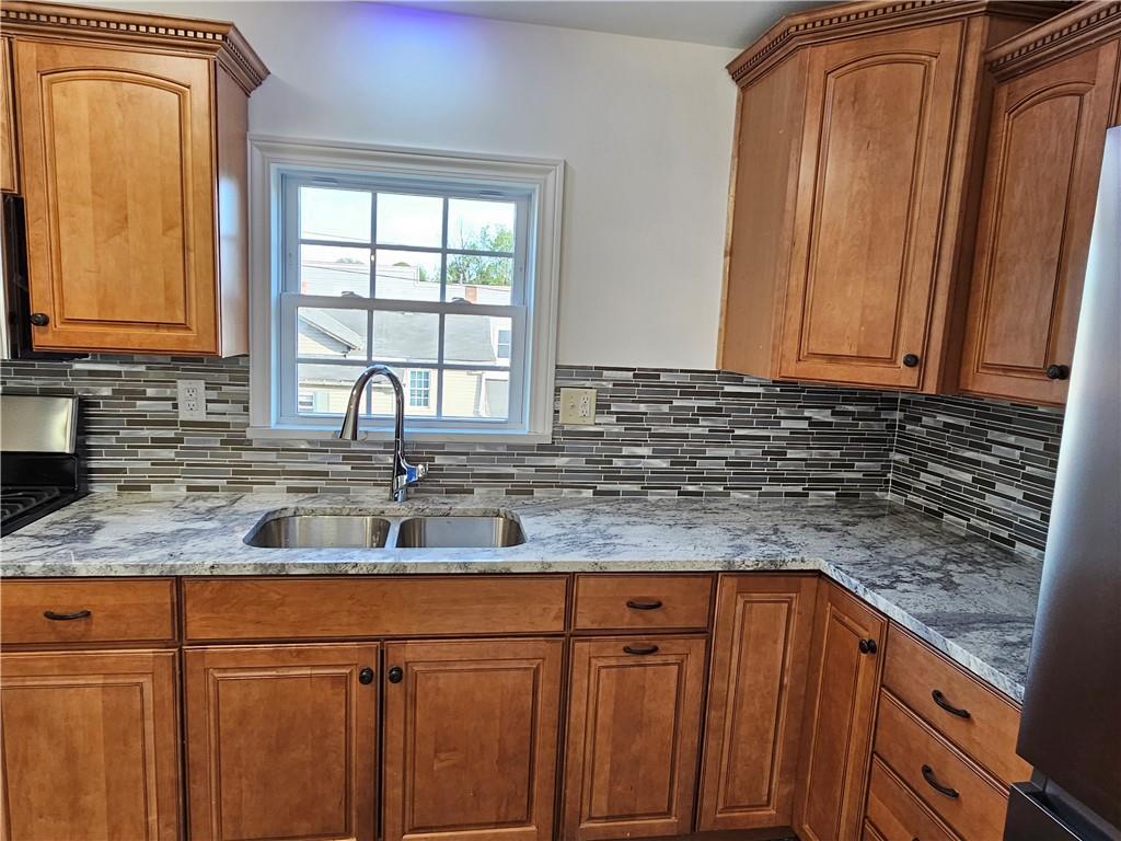 536 Virginia Avenue Rochester, PA 15074 - Photo 9 of 24 a kitchen with granite countertop cabinets sink and window