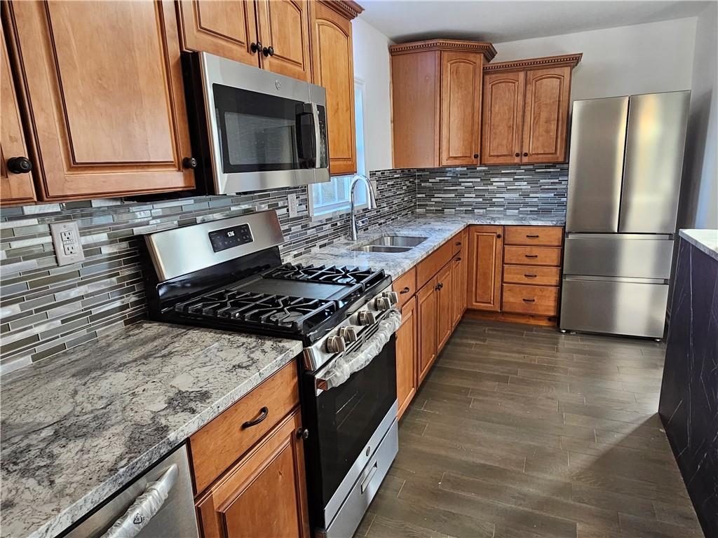 536 Virginia Avenue Rochester, PA 15074 - Photo 10 of 24 a kitchen with stainless steel appliances granite countertop a stove a sink and a microwave