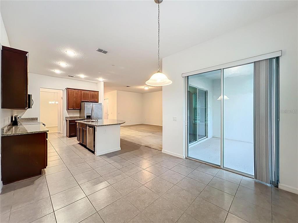 12821 Westside Vlg Loop Windermere, FL 34786 - Photo 11 of 42 a large kitchen with granite countertop a large counter top and appliances