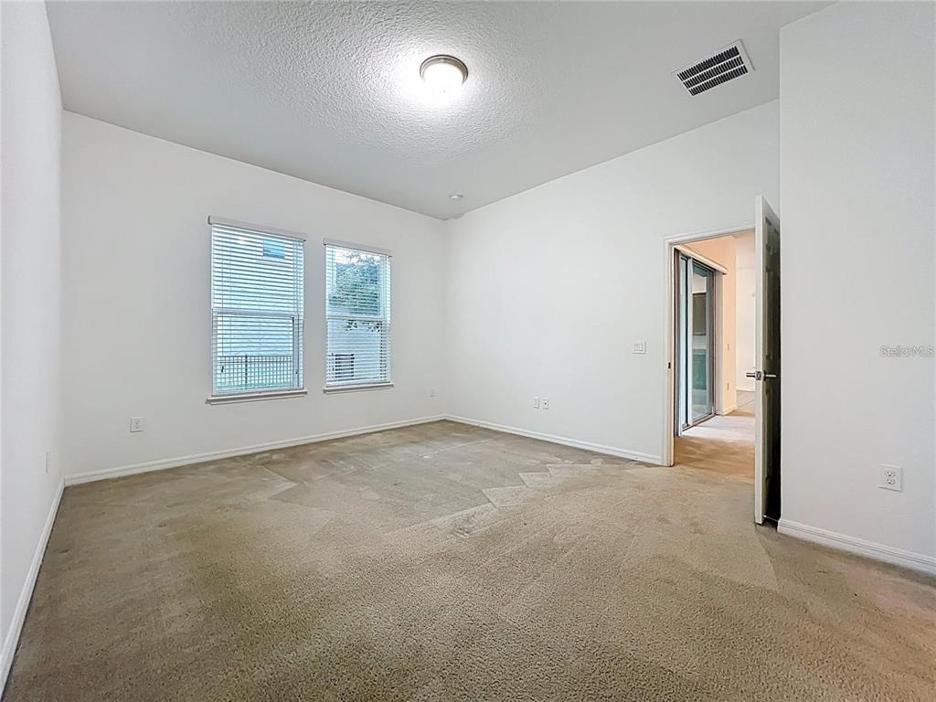12821 Westside Vlg Loop Windermere, FL 34786 - Photo 19 of 42 an empty room with windows and closet