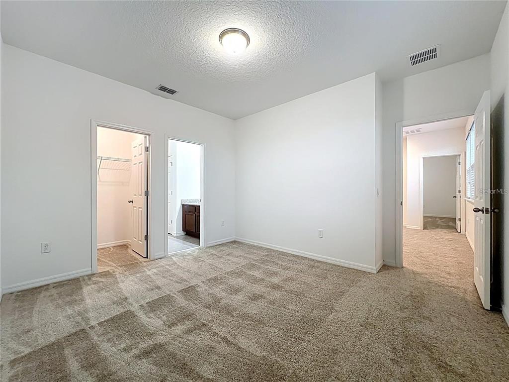 12821 Westside Vlg Loop Windermere, FL 34786 - Photo 27 of 42 a view of a livingroom with wooden floor and staircase