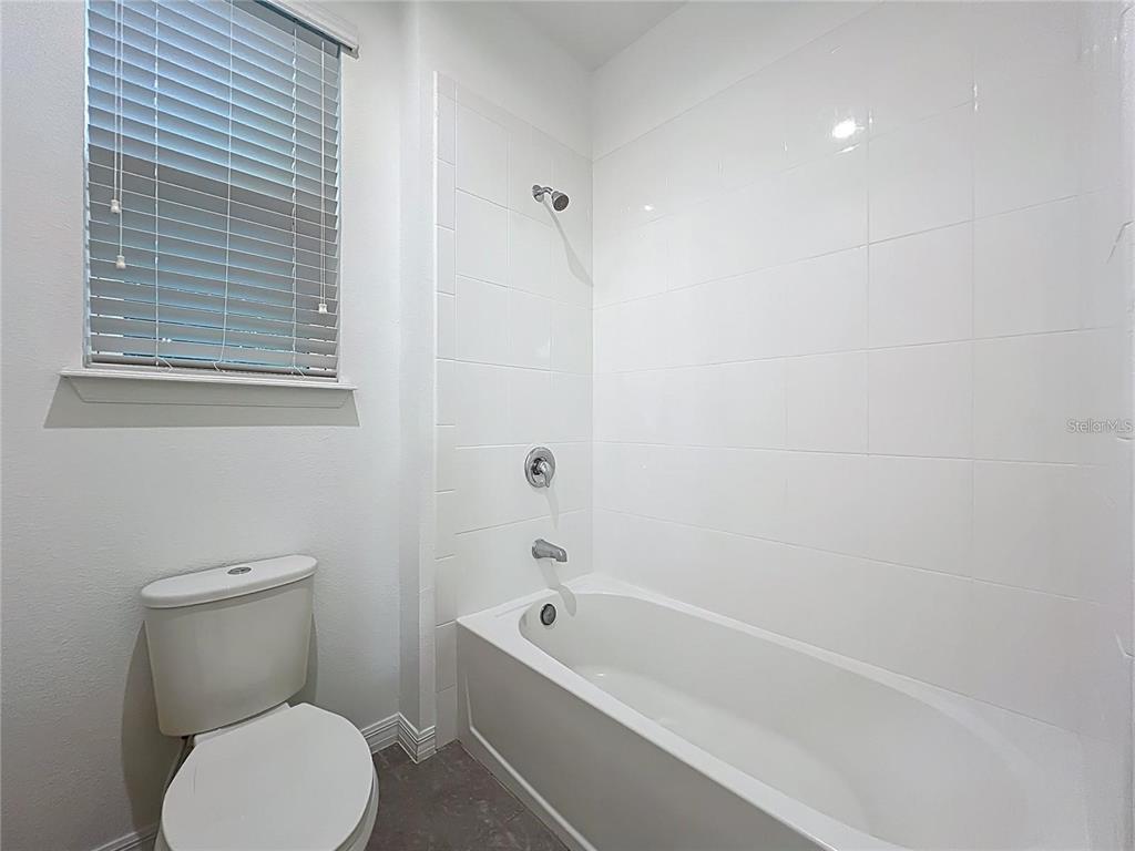 12821 Westside Vlg Loop Windermere, FL 34786 - Photo 31 of 42 a white toilet sitting next to a bath tub