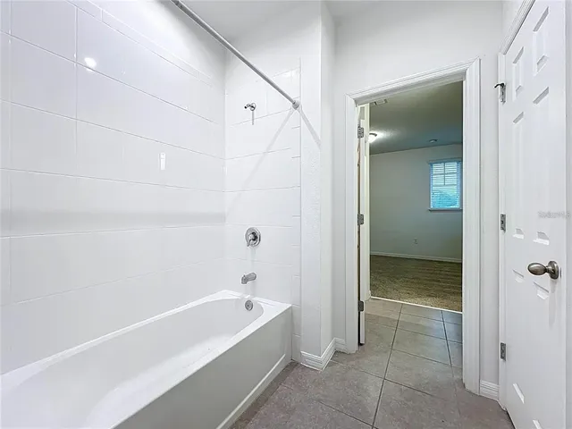 a bathroom with a bathtub and shower
