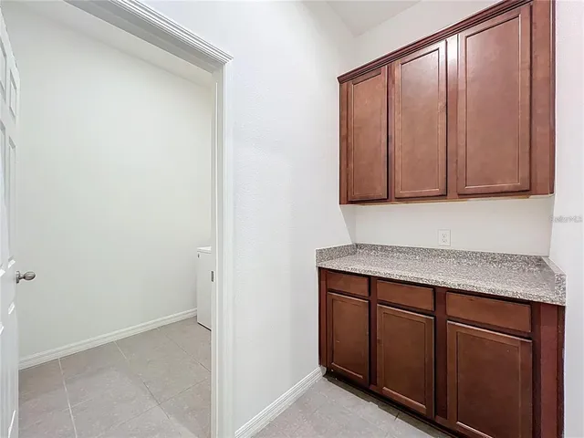 a view of a street with a cars parked and small park