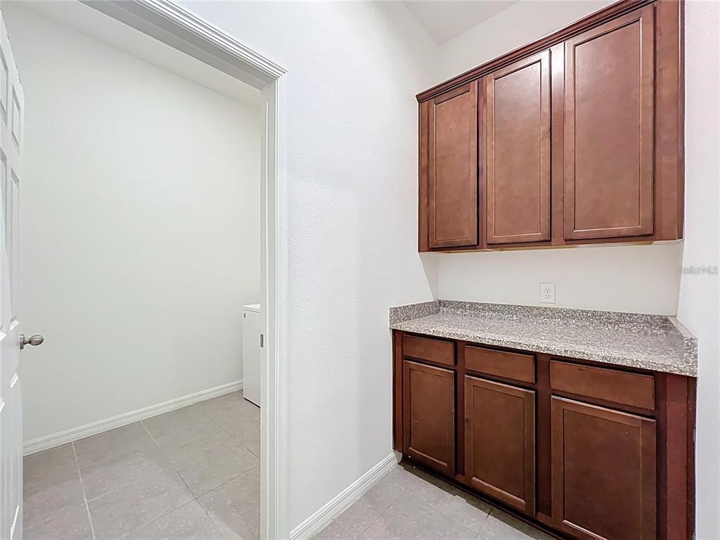 12821 Westside Vlg Loop Windermere, FL 34786 - Photo 38 of 42 a view of cabinets and wooden floor