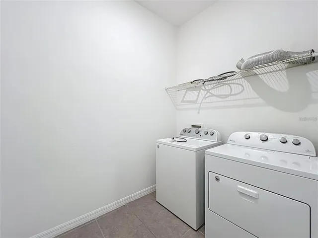 a view of a house with a swimming pool and sitting area