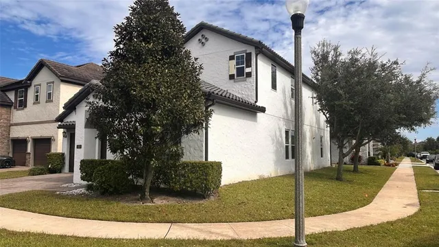 a view of a house with a backyard