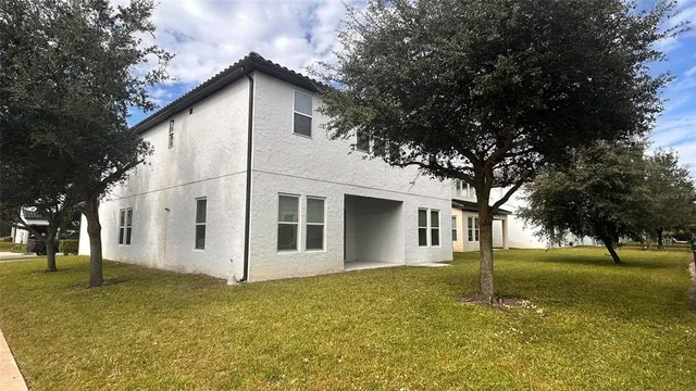 a view of a white house with a yard