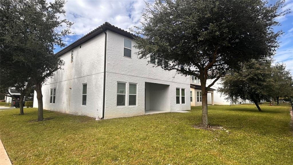 12821 Westside Vlg Loop Windermere, FL 34786 - Photo 5 of 42 a view of a white house with a yard