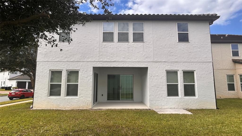 12821 Westside Vlg Loop Windermere, FL 34786 - Photo 6 of 42 a front view of a house with a garden
