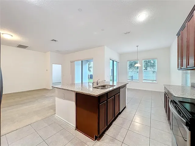 a kitchen with stainless steel appliances granite countertop a stove and a sink