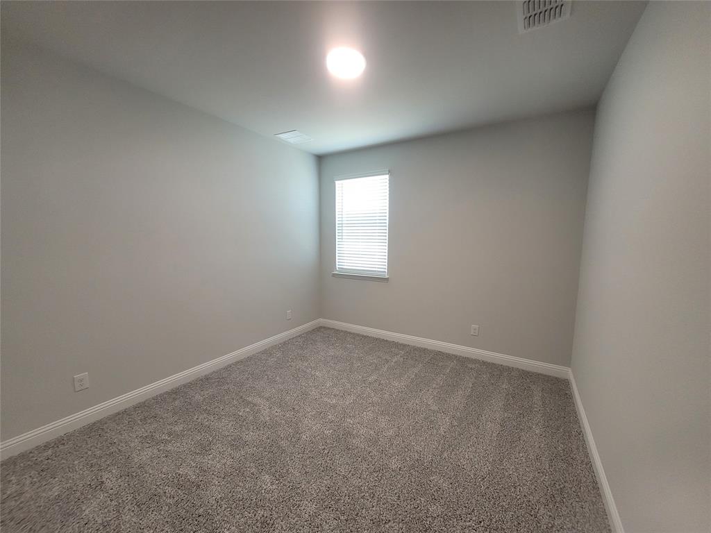 2702 Island Palm Court Forney, TX 75126 - Photo 12 of 15 an empty room with a window and closet