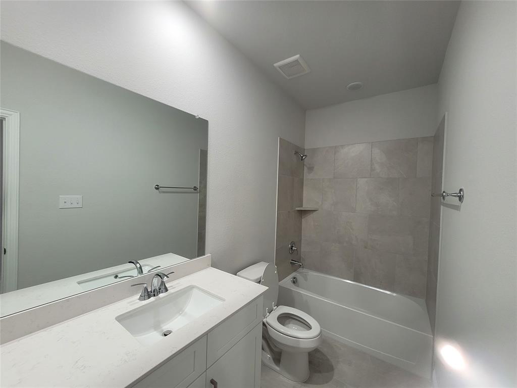 2702 Island Palm Court Forney, TX 75126 - Photo 13 of 15 a bathroom with a sink mirror toilet and bathtub