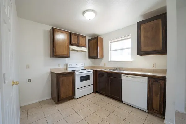 a kitchen with a sink stove and cabinets