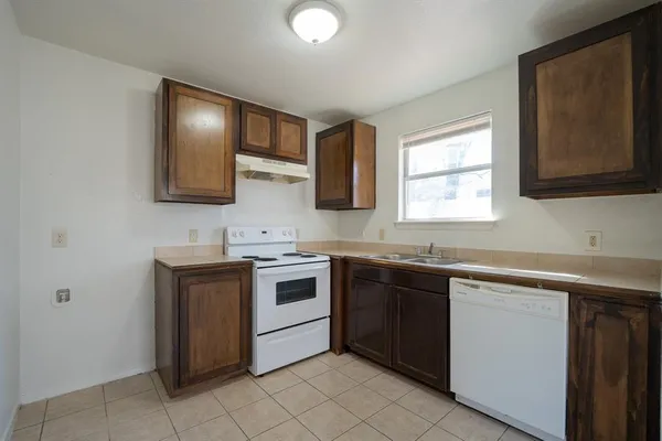 a kitchen with stainless steel appliances granite countertop a sink stove and microwave