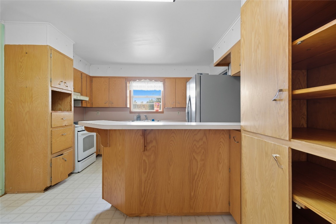 508 Morris Drive Georgetown, TX 78628 - Photo 28 of 40 a kitchen with cabinets and a refrigerator