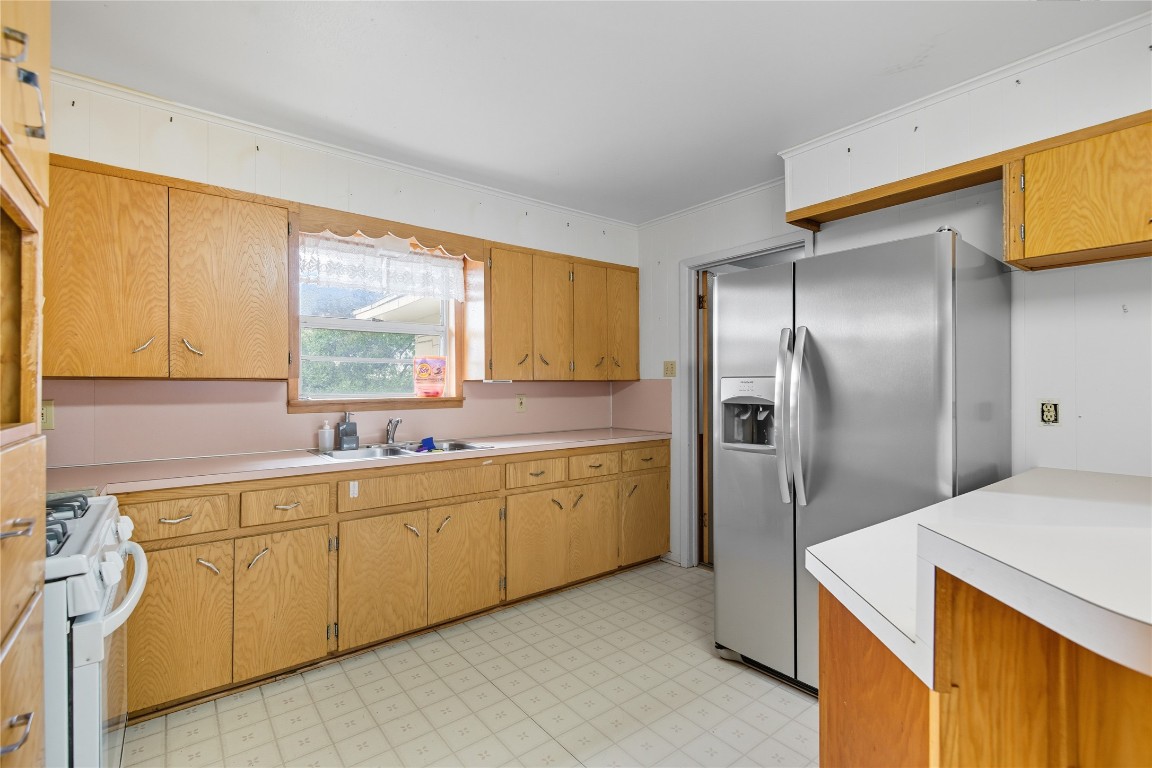 508 Morris Drive Georgetown, TX 78628 - Photo 29 of 40 a kitchen with stainless steel appliances a refrigerator sink and cabinets