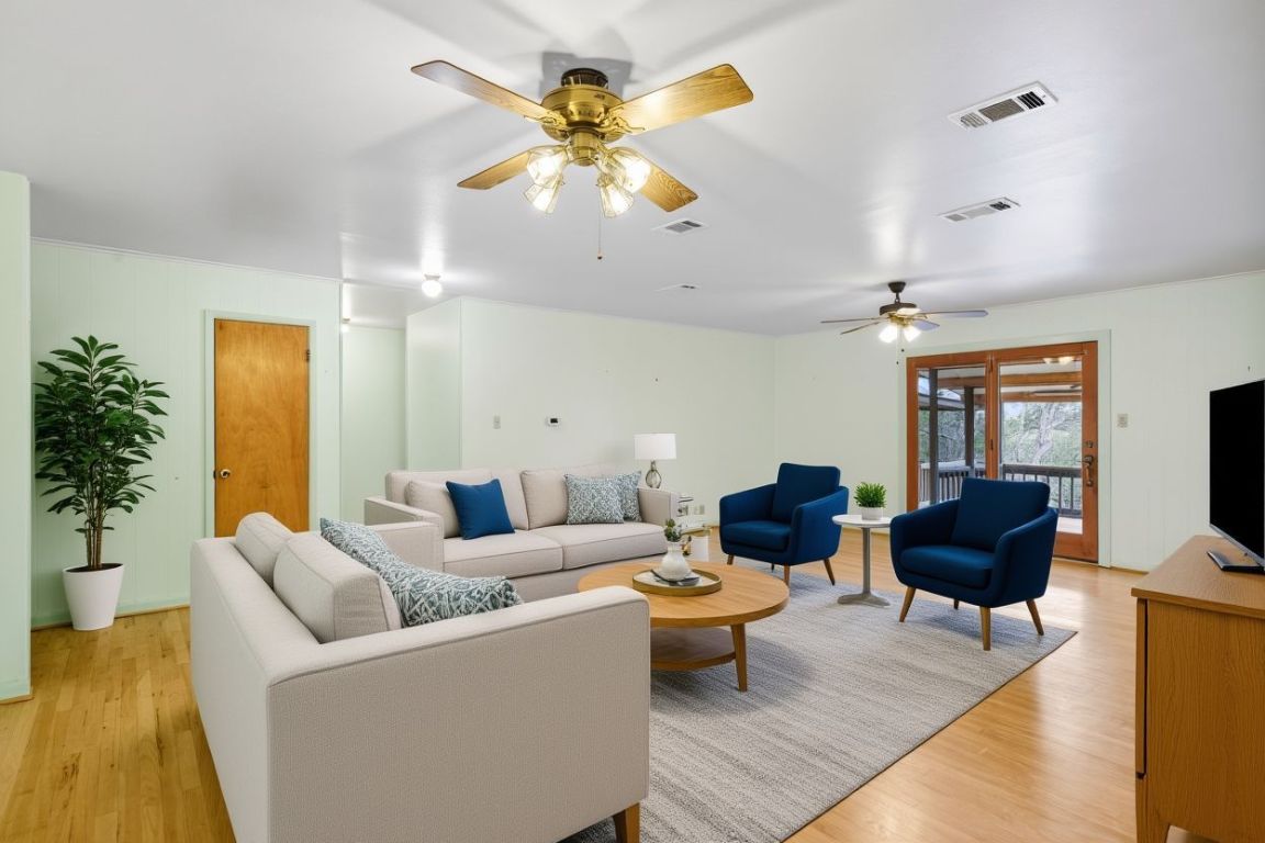 508 Morris Drive Georgetown, TX 78628 - Photo 4 of 40 a living room with furniture a chandelier and a flat screen tv