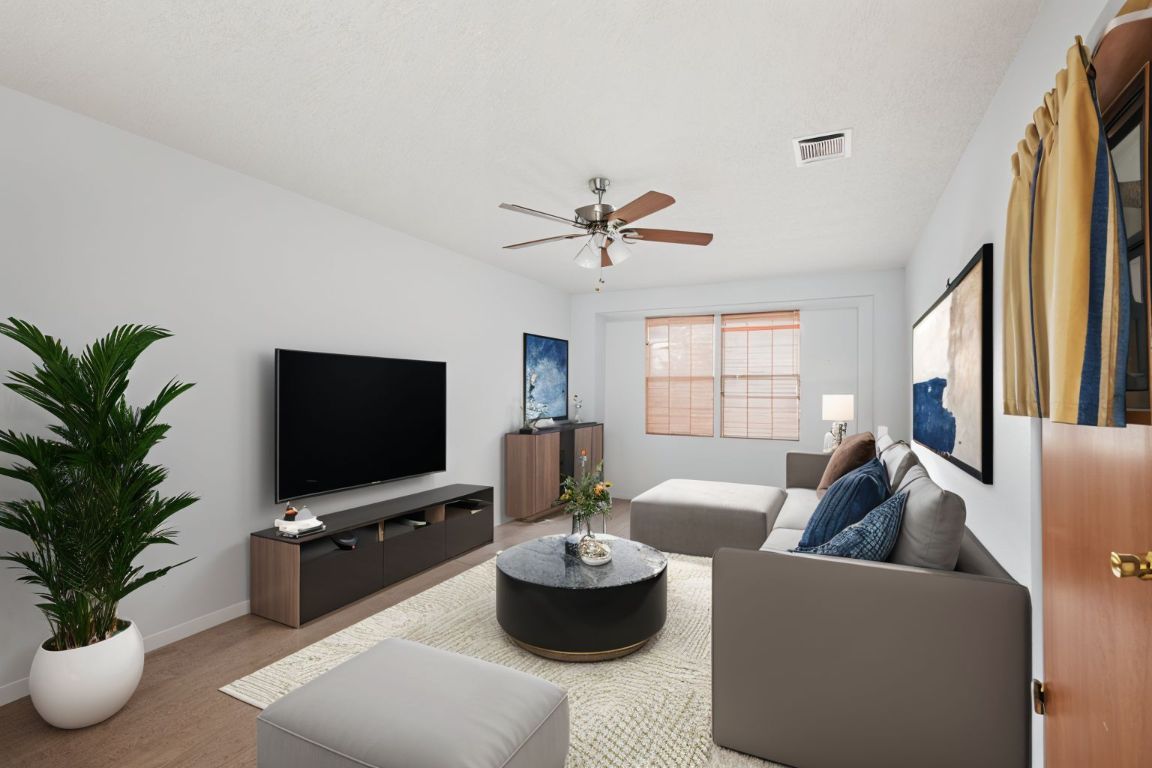 508 Morris Drive Georgetown, TX 78628 - Photo 10 of 40 a living room with furniture and a flat screen tv