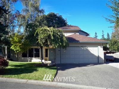 23 235th Place Southwest Bothell, WA 98021 - Photo 1 of 1 a front view of a house with a garden and a yard