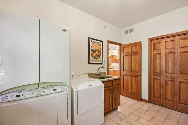 a bathroom with a granite countertop tub sink and mirror