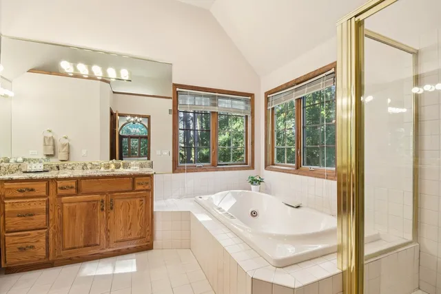 a bathroom with a granite countertop sink mirror and double
