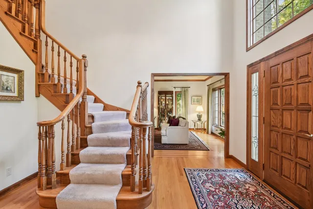 a view of entryway and hall with wooden floor