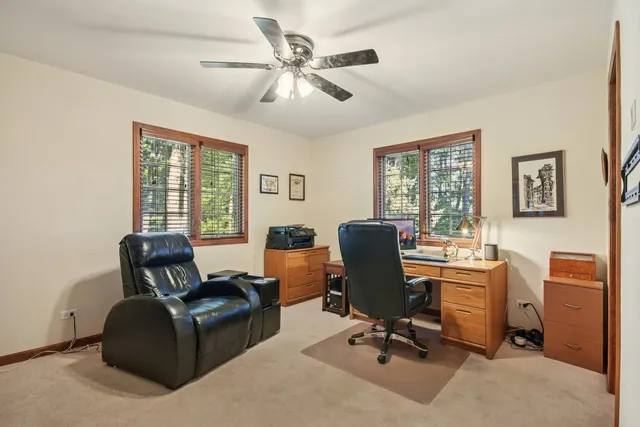 a view of a patio with a table chairs and wooden fence