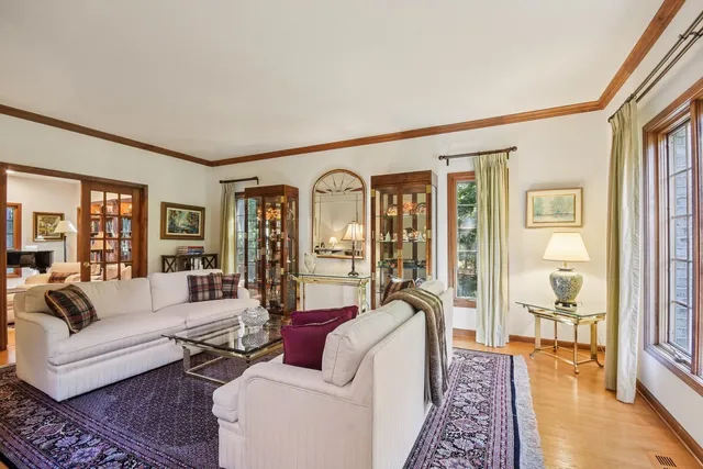a living room with furniture and a floor to ceiling window